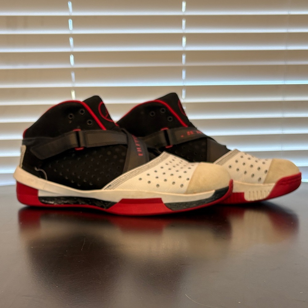 Black and Red High-Top athletic Jordan’s size 13.5